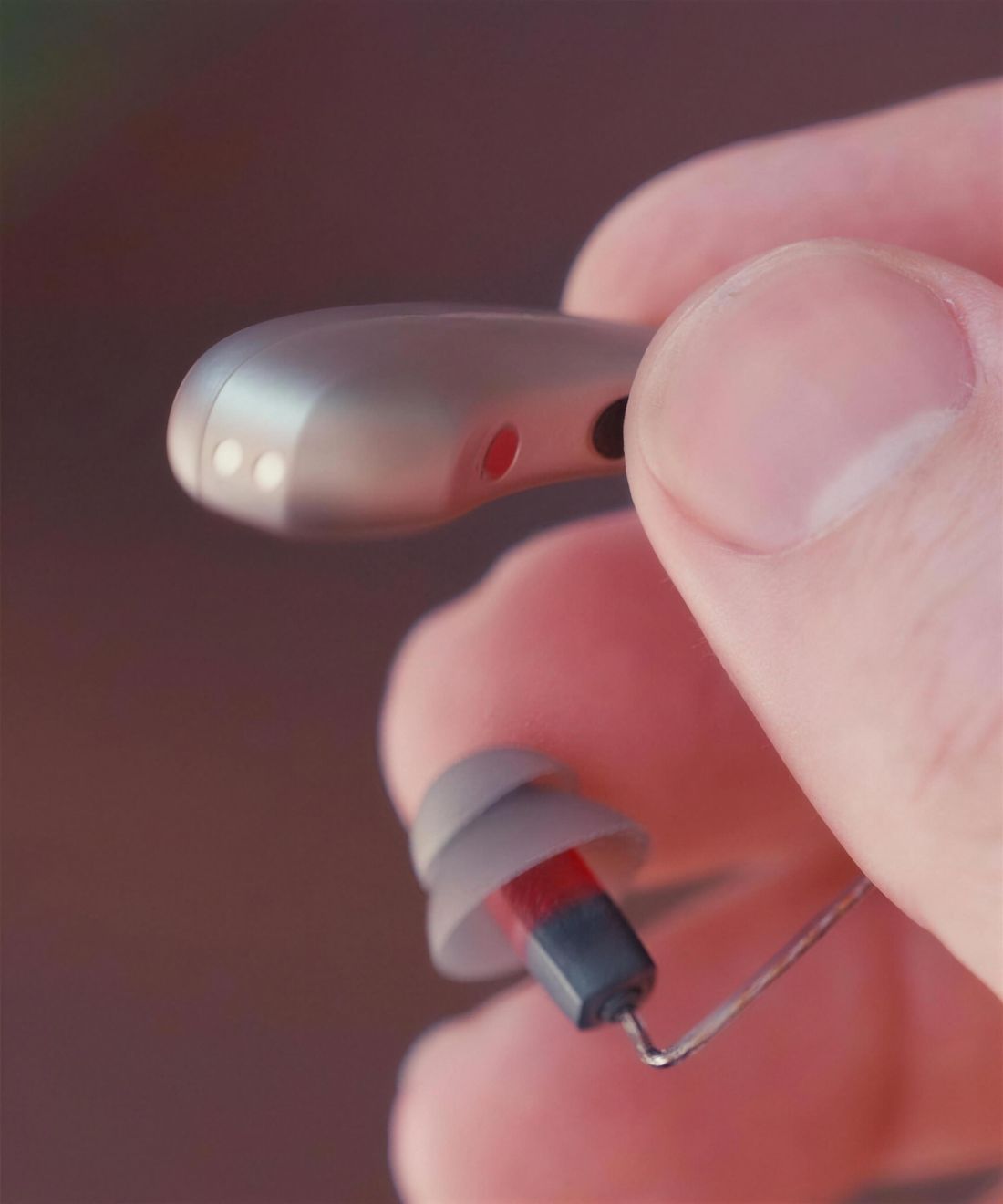 A Clarion Clarity S3 hearing aid held between two fingers